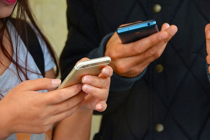 People texting on their phones.