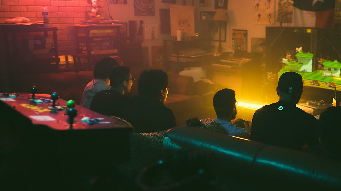 Gamers surrounding TV