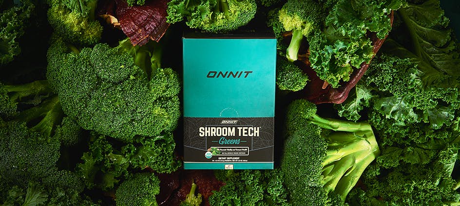 Shroom Tech Greens Box surrounded by vegetables.